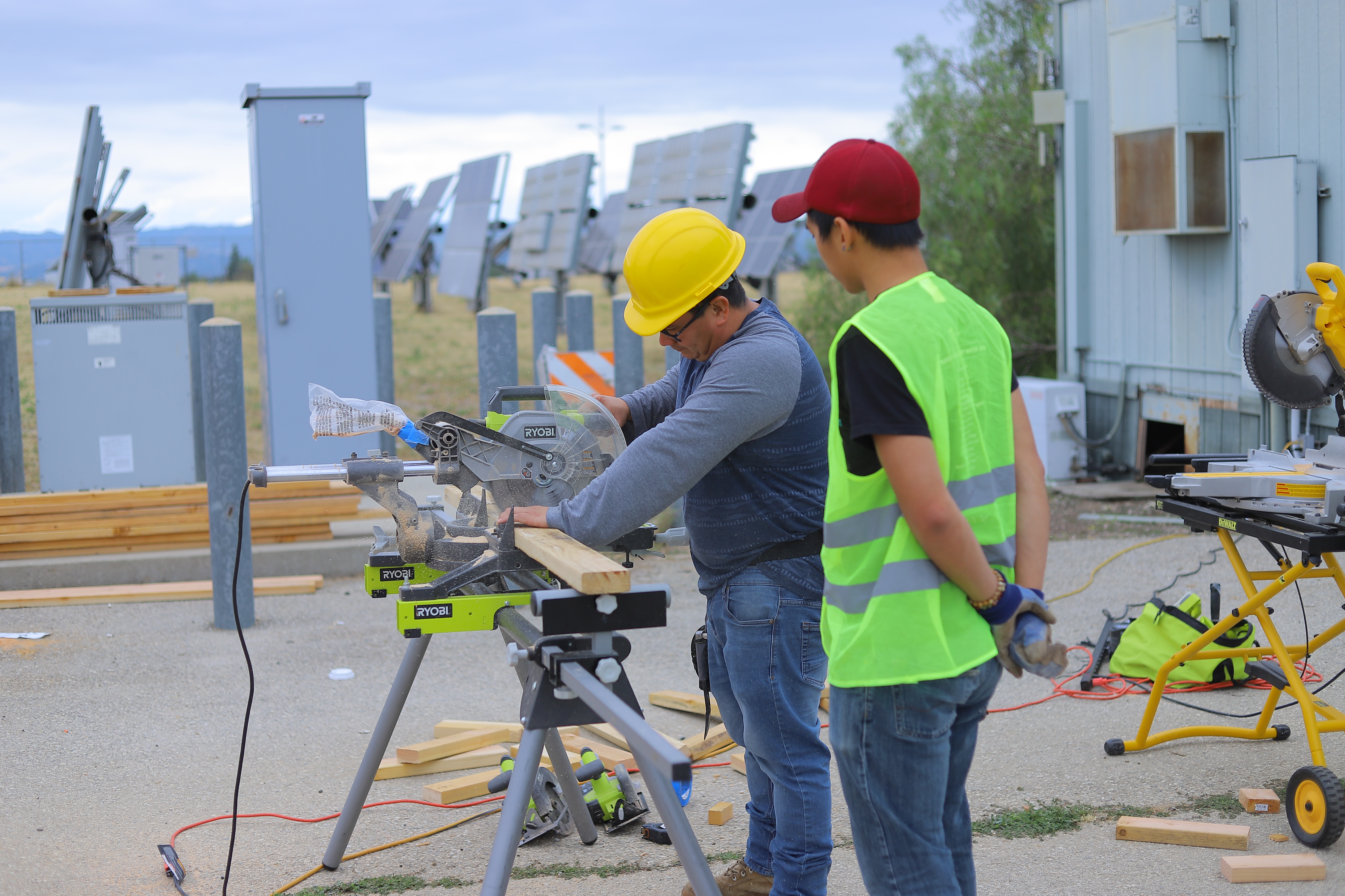 Students cutting wood for the project